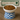 White bowl with blue checkered base filled with cat food, branded 'Feline Fancy' in the background.
