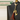 Black leather bag with a gold cat charm and red tassel, branded 'Feline Fancy'.