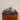 A sterling silver ring with a cat motif, displayed on a wooden stand with a grey fabric underneath.