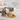 Cat drinking from a elevated ceramic bowl on a wooden stand in a living room.