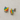 Pair of rainbow-colored earrings on a light gray background