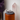 Silver paw-shaped rings on a gray cushion with a wooden stand against a blurred natural background