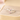 Silver ring with pink cat ears and paw print on a beige background