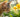 A tabby cat nibbling on a daffodil leaf in a garden