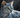 The Egyptian Mau laying on rocks, looking cute.