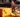 Cat looking at eating cheese with Feline Fancy logo.