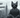 A sleek and stylish grey cat sits confidently, wearing silver aviator sunglasses and a perfectly tailored grey suit.