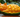 A mango on a table, the Mango has been carved into a Cat.