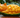 A mango on a table, the Mango has been carved into a Cat.