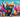 A colorful, street-art-style mural featuring a cool tabby cat wearing sunglasses and a hoodie, spray-painting the words "250 Tabby Cat Names" in bold
