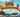 An outdoor cat festival set in a sunny park with stalls, bunting, and costumed cats. A giant balloon arch at the entrance is shaped like a cat face, and across the arch it says "500 Popular Cat Names"
