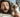 Pet owner looking surprised as their cat suddenly licks their hand, light bright image bold colours.