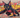 urban graffiti-style artwork of a cartoon warrior cat posed mid-leap with claws out, surrounded by spray-paint textures, layered stencils, and scratch marks on a cracked wall backdrop.