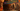 Vibrant animated bazaar with colorful stalls displaying name tags in Arabic and English