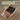 Pink wallet with gold zipper on a wooden surface, branded 'Feline Fancy'.