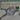 Silver cat-shaped dish with a large gemstone on a blurred 'Feline Fancy' background