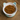 Cat food in a white bowl with teal ears on a wooden floor