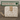Beige wallet with cat illustrations on a wooden surface, branded 'Feline Fancy'.