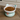Cat-shaped food bowl with kibble on a wooden floor, featuring the brand 'MIAOFAIRY'.