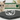 Silver crown with cat designs on a dark surface, with a cat and 'Line Fancy' product in the background.