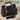 Black handbag with gold handle and cat charm on a white surface