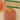Gold ring on a pink cushion with a blurred 'Feline Fancy' product in the background
