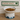 White bowl with pet food on a wooden surface, branded 'Feline Fancy'.