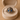 Cat-shaped ring with blue eyes in a beige jewelry box on a wooden surface