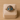 Silver ring with blue stone eyes in a beige jewelry box on a beige background