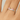 Silver ring with pink triangle details on a hand against a neutral background