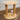 Wooden cat toy with vertical and horizontal scratching posts on a wooden floor.