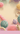 Colorful yarn balls and knitting tools on a pink background