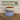 White cat bowl with blue checkered base containing cat food, branded 'Feline Fancy' in the background.
