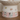 Ceramic pet bowl with cartoon cat designs on a wooden surface