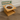 Wooden pet feeder with a bowl of kibble on a wooden floor, branded 'Feline Fancy'.