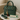 Green handbag with gold accents and a tassel on a marble surface, accompanied by a 'Feline Fancy' card.