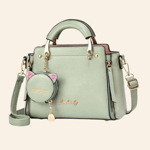 Crafted with high-quality materials, the Kitty Charm Handbag is both durable and stylish, making it perfect for everyday use