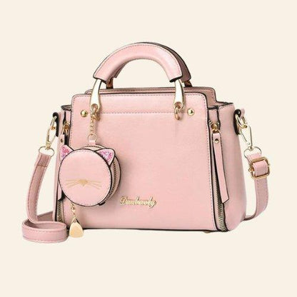 The Kitty Charm Handbag combines elegance and personality, offering a practical design with a delightful cat-inspired charm