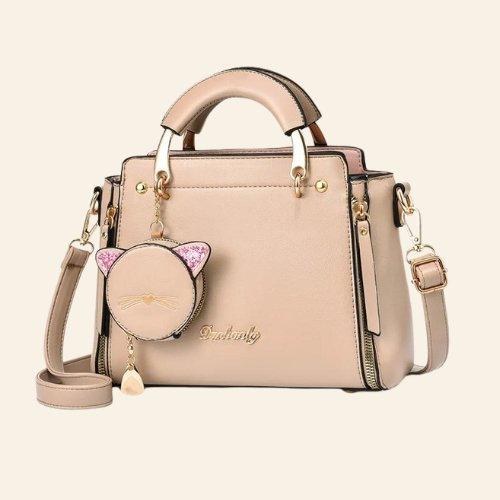 Perfect for both casual and dressy occasions, the Kitty Charm Handbag adds a unique, playful touch to any look