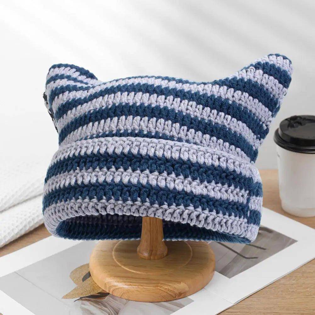 Add comfort and charm to your cold-weather attire with the cozy and cute Snuggle Cat Hat