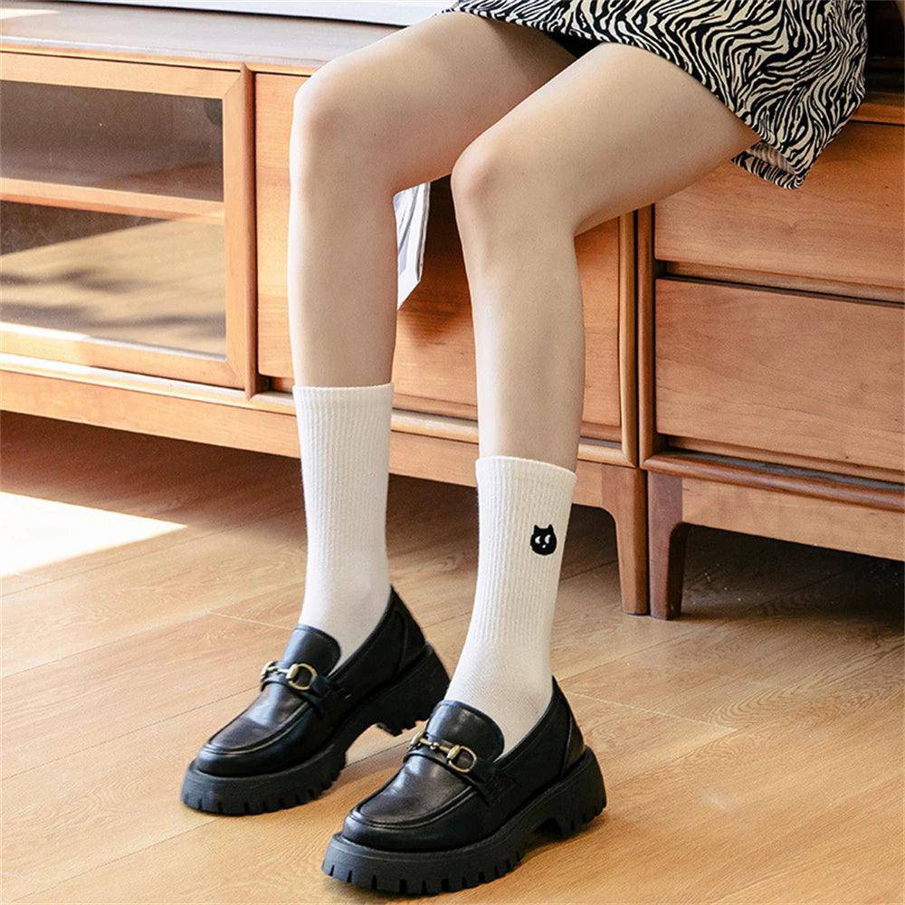 Add a touch of elegance to your wardrobe with the simple yet striking Black Cat Socks